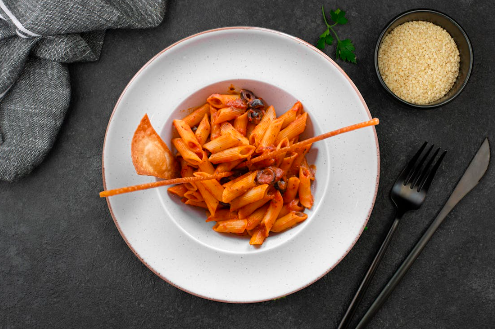 White plate that has pasta inside.