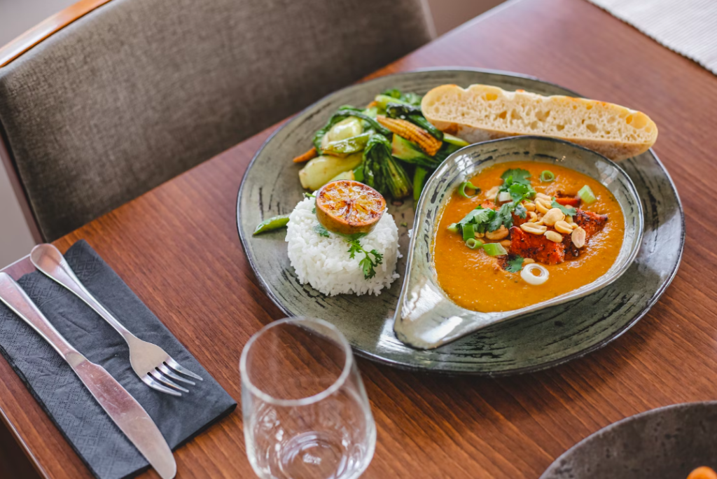 An entree that has rice, bread and soup.